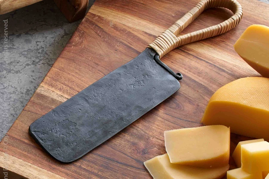 A metal cheese cleaver next big cheese chunks