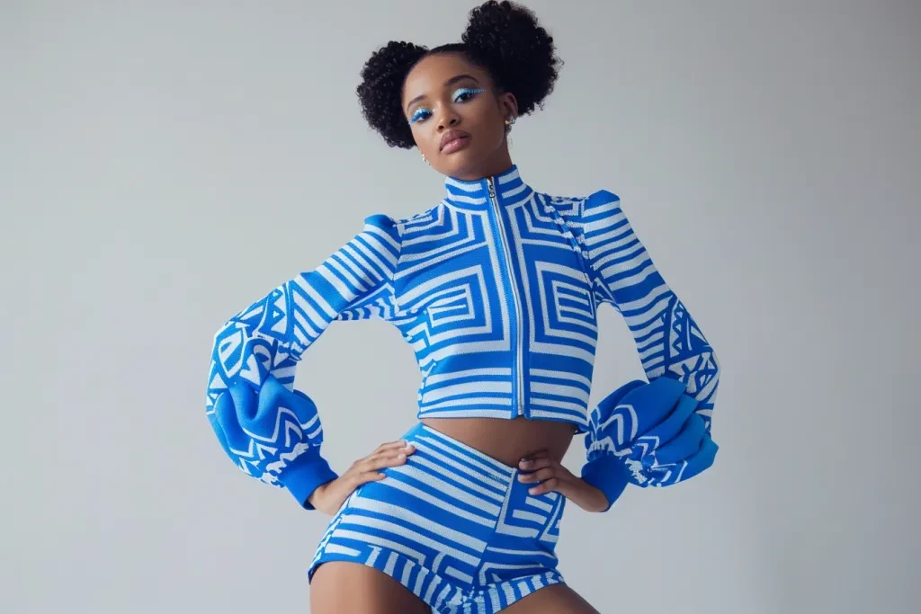 A model wearing a blue and white patterned long sleeve top with shorts