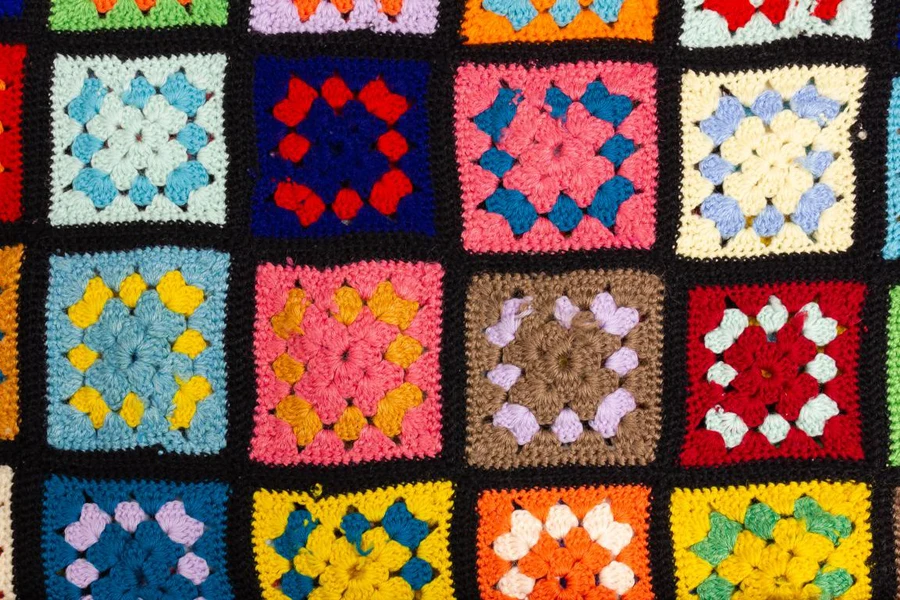 A multicolored woolen throw blanket