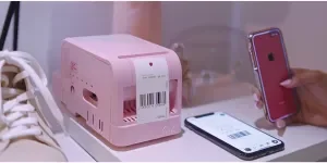 A small pink label printer