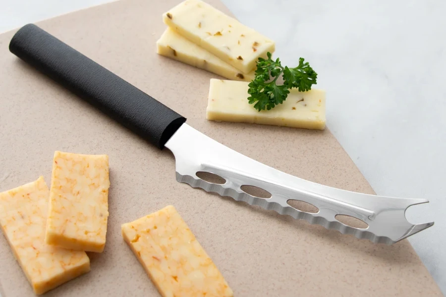 A soft cheese knife with some cheese slices