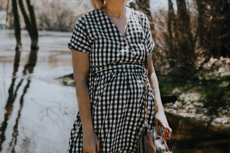 A woman in a wrap dress with mid-size gingham checks