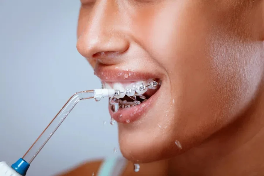 A woman is using Water picks in her hand