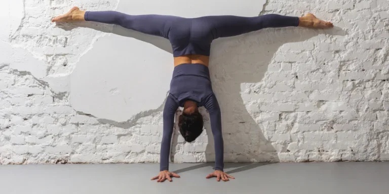 A woman trainer practicing yoga performs