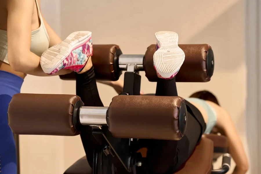 A woman training her legs with leg curls