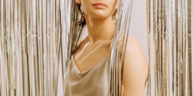 Adorable narcissistic woman dressed gold glamour outfit glitter curtain background