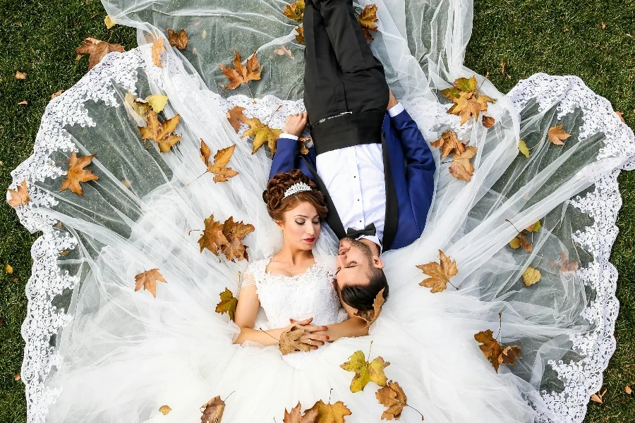 Aerial Photo of Man and Woman Lying on Grass Field