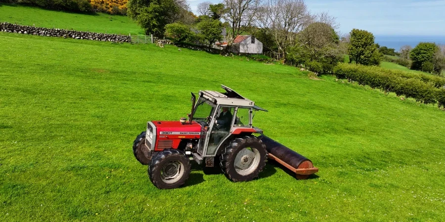 Aerial view of Massey Ferguson 390T rolling fields at Ballygawn Farm Co Antrim Northern Ireland