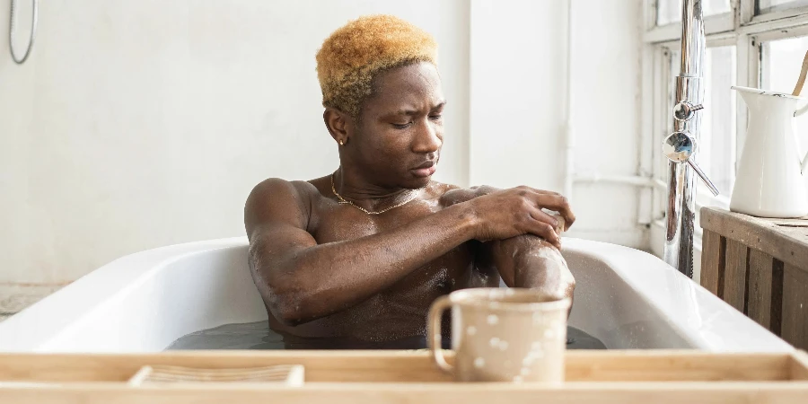 man scrubbing arms with sponge and soap