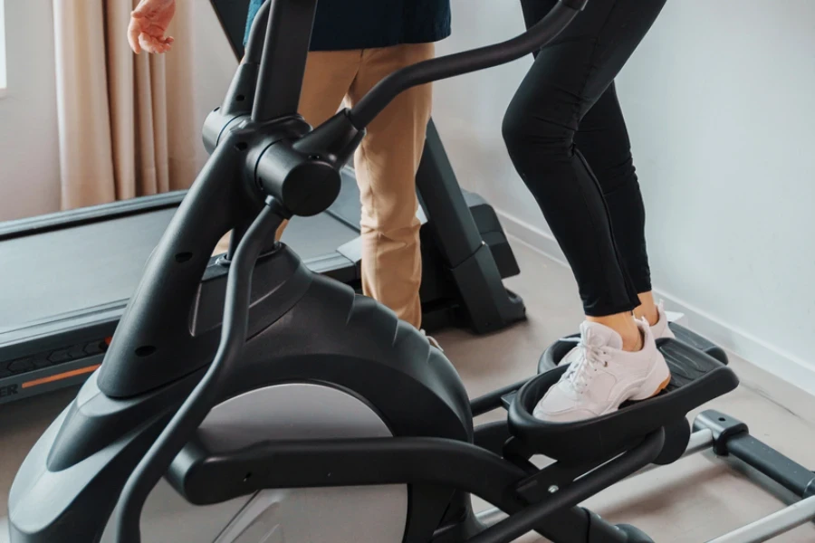 An elderly lady is using a step machine