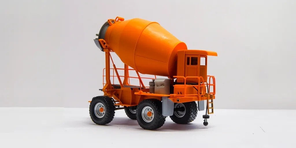 An orange cement mixer on wheels against a white background