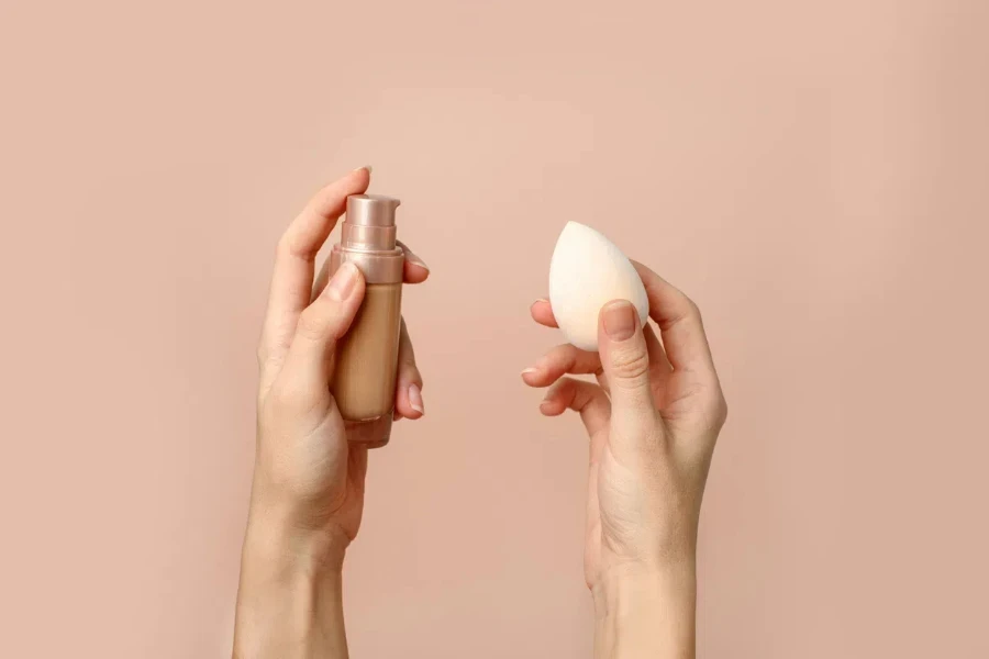 Applying foundation on makeup sponge