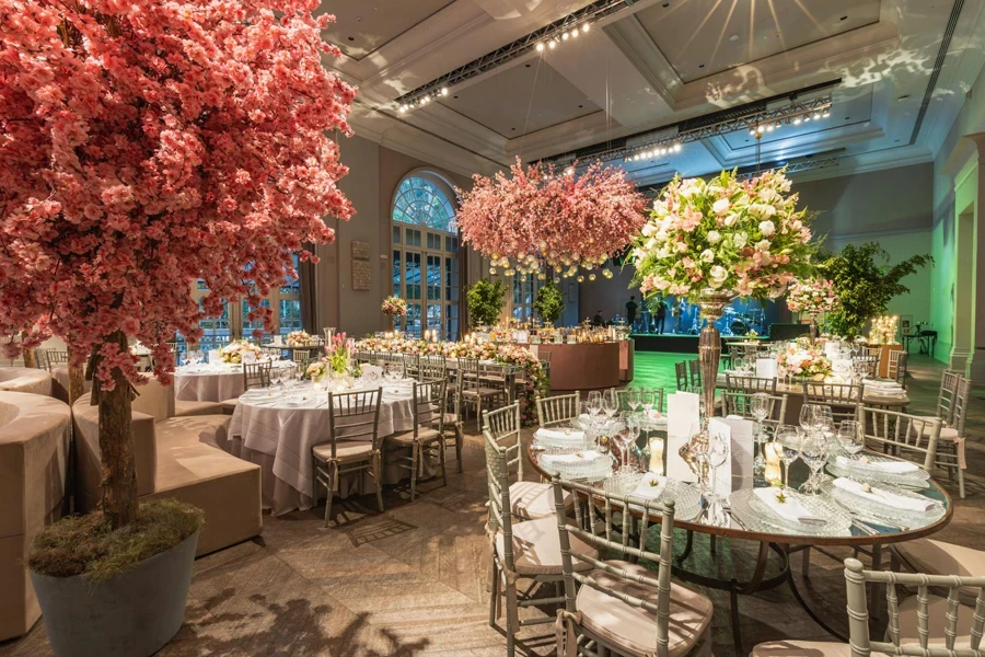 Artificial Cherry Trees Decorating a Luxury Hall for a Wedding Reception 