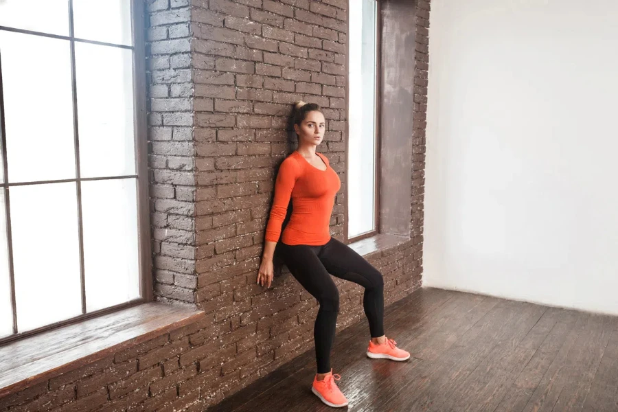 Balancing exercise. Activity woman looking at camera and doing workout. Studio shot 