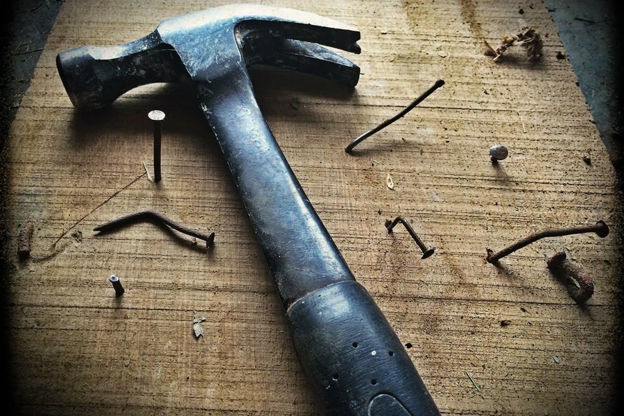 Black Claw Hammer on Brown Wooden Plank