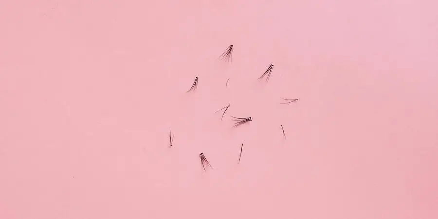 Black Eye Lashes on Pink Surface by Nataliya Vaitkevich