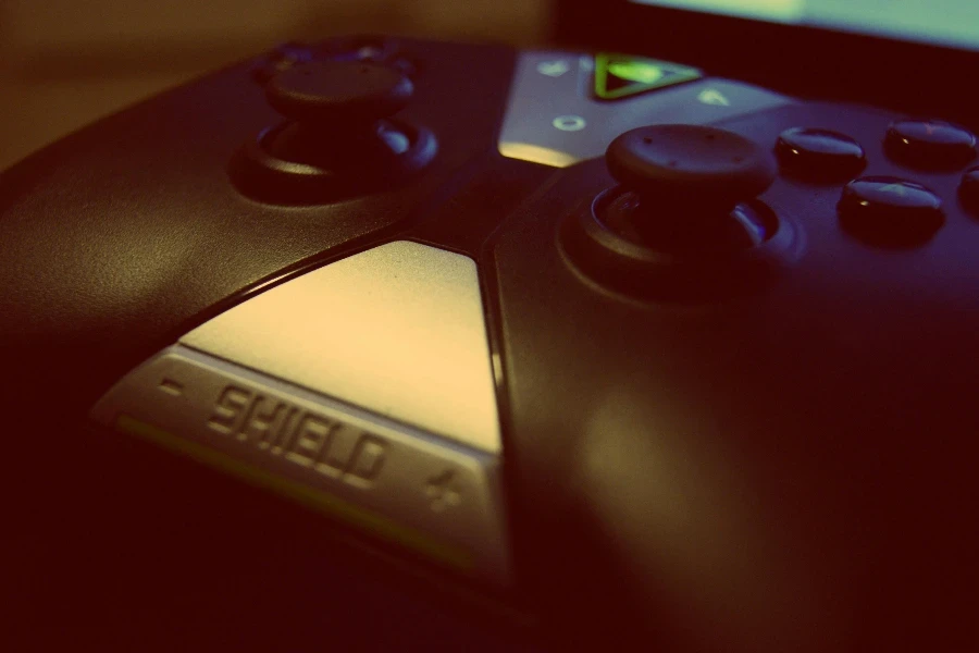 Black Shield Game Controller Close-up Photography by Johnny Mckane