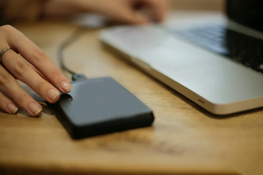 Black Square Device on Brown Wooden Table