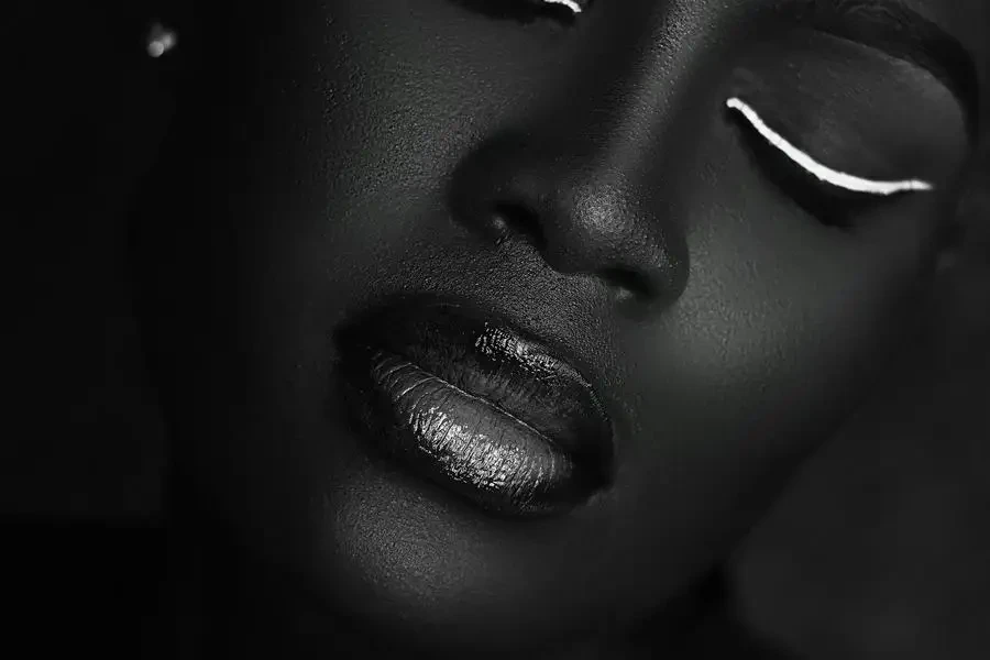 Black and White Portrait of a Woman Wearing White Eyeliner by Nemmy Media