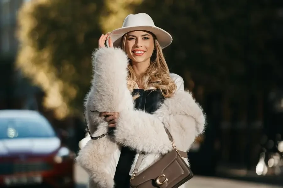 Blonde Woman Wearing Fur Coat on a Street by Andras Stefuca