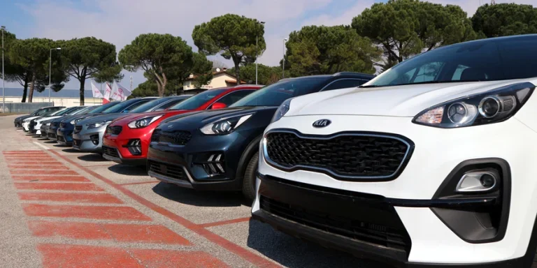 Brand new Kia cars lined up outside the dealership