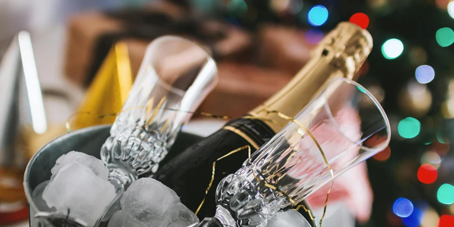 Brown Labeled Bottle and Two Clear Glass Champagne Flutes