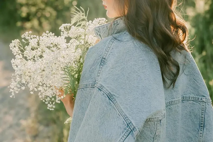 Brunette Woman Holding a Bouquet of White Flowers by Larissa Farber