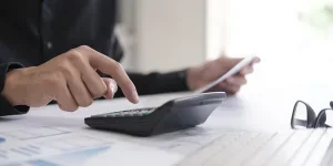 Business man using calculator finance and accounting concept