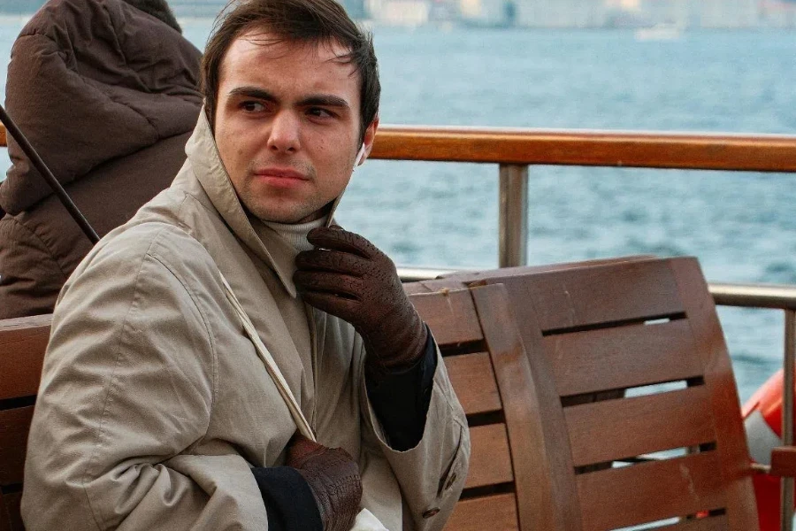 Candid Photo of a Man Sitting on a Ferry Crossing the Bosphorus Strait in Istanbul