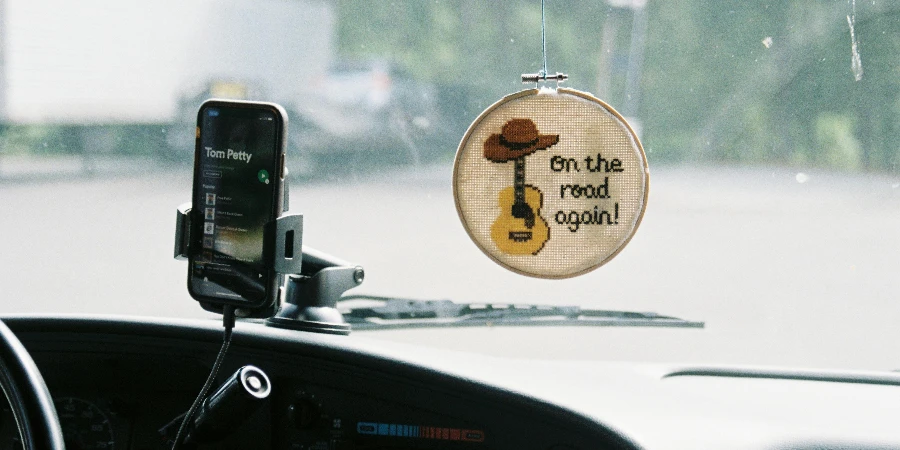 Car Decor and Cellphone on Windshield