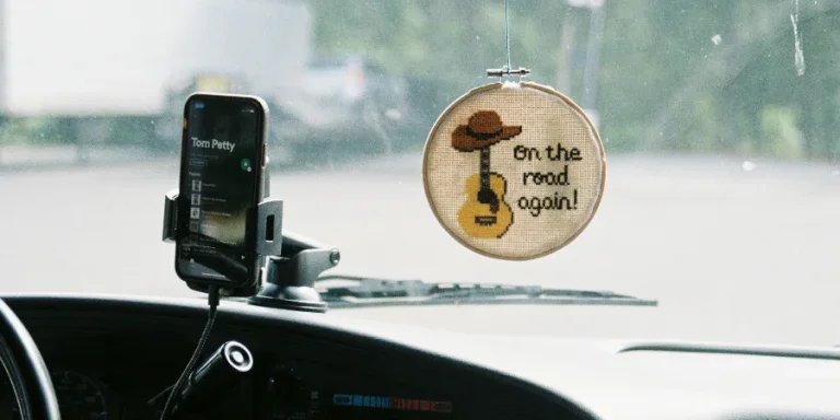 Car Decor and Cellphone on Windshield