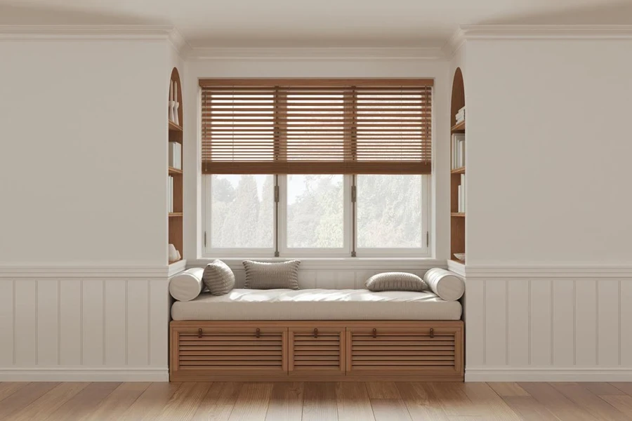 Classic window with siting bench and pillows. Wooden venetian blinds, bookshelf and decors. White walls with copy space for text. Modern interior design