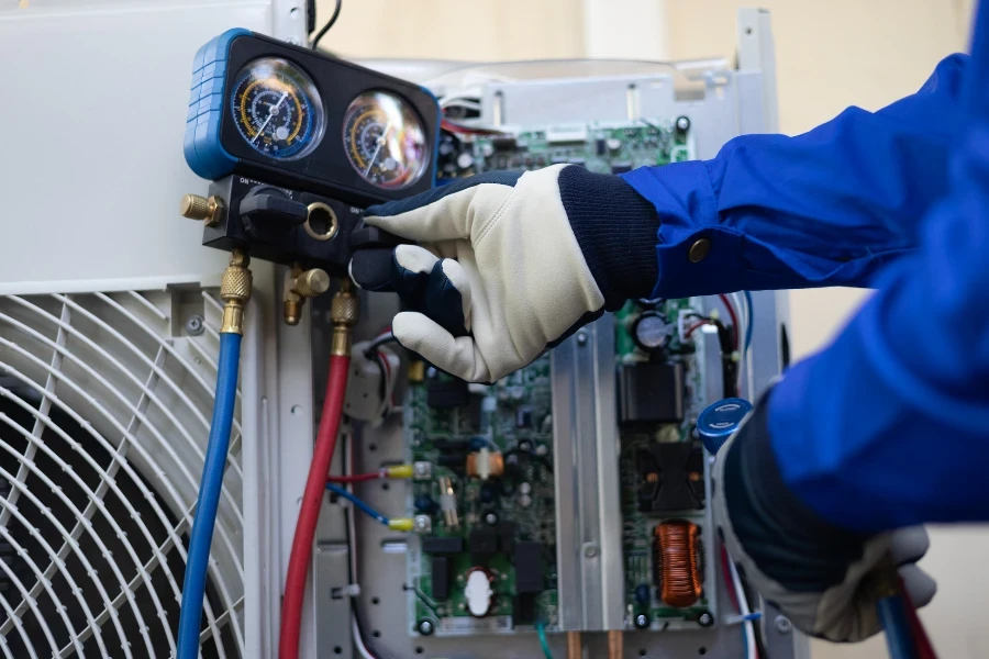 Close-up Air conditioner technician hand check fill refrigerant liquid and maintenance condenser unit