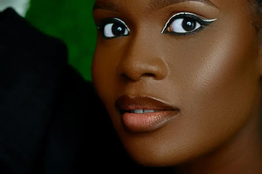 Close-up Portrait of a Young Woman in a Makeup Look with White Eyeliner by Nemmy Media