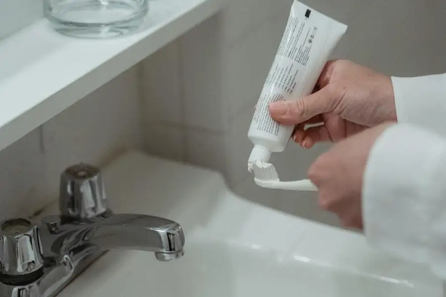 Close-up of Person Brushing Teeth with Toothpaste by Miriam Alonso