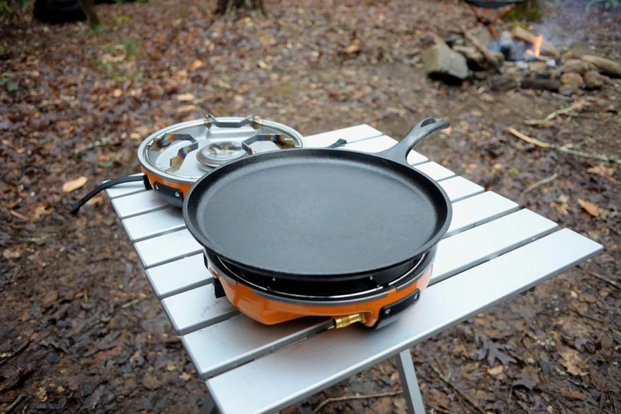 Close up of cast iron griddle on camp stove in campsite