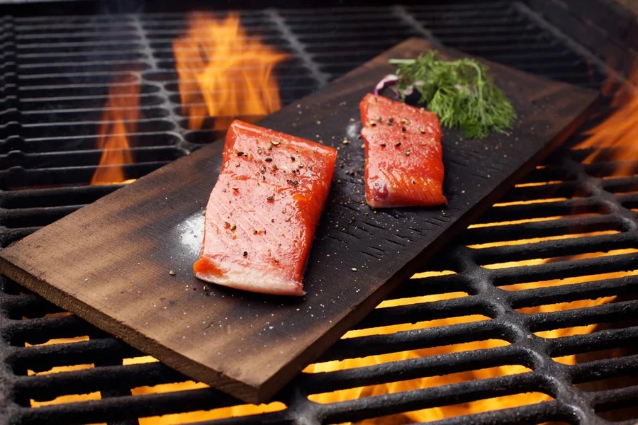 Closed grill with green lid outdoors on grey brown stone wall background.