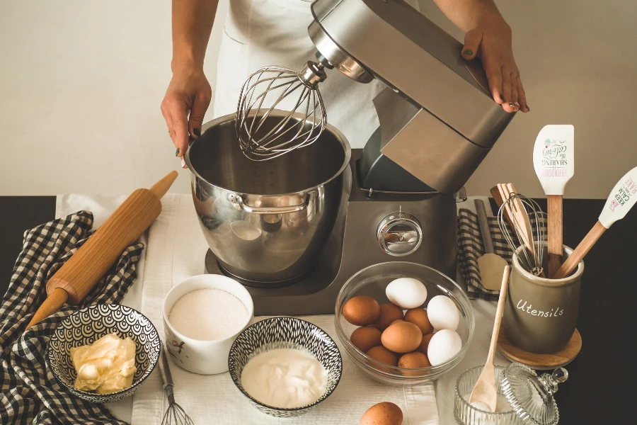 Confectioner girl is preparing a cake