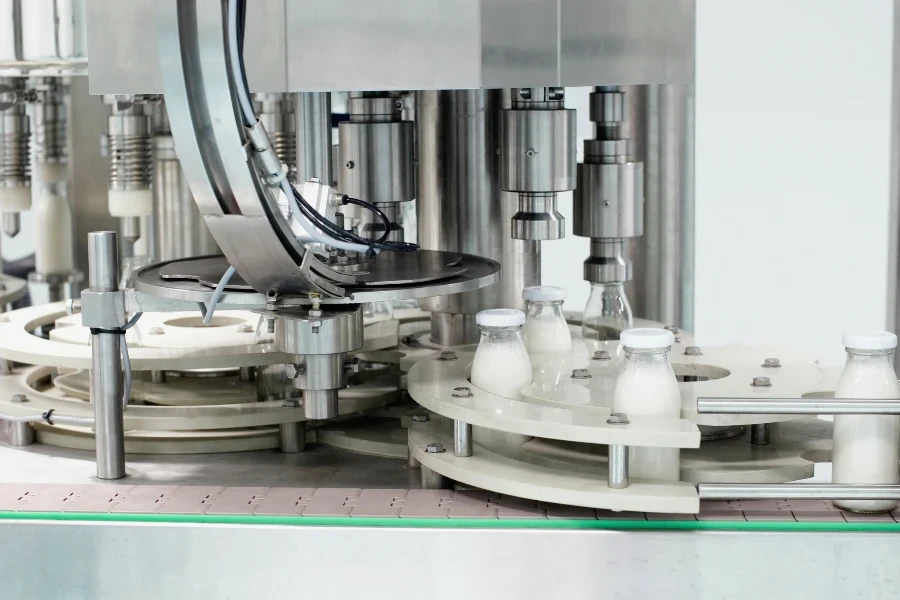 Conveyor with glass bottles filled with milk products