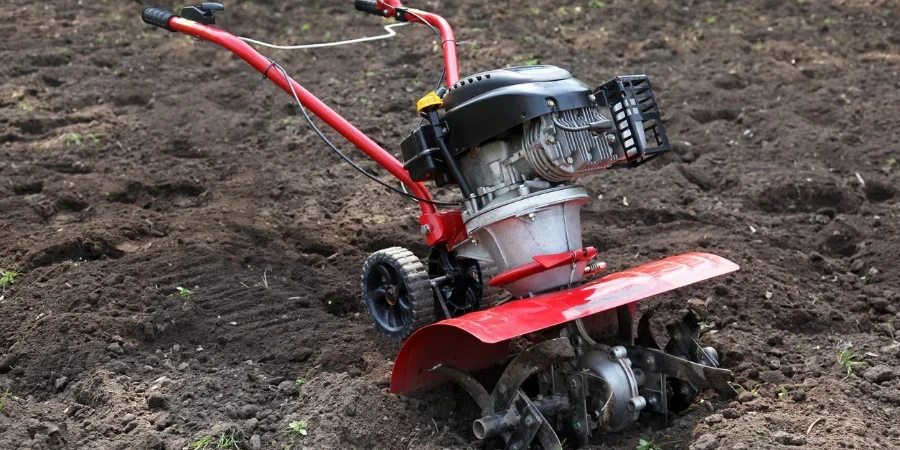 Cultivator in the garden to prepare the soil for planting vegetables at the beginning of the spring season