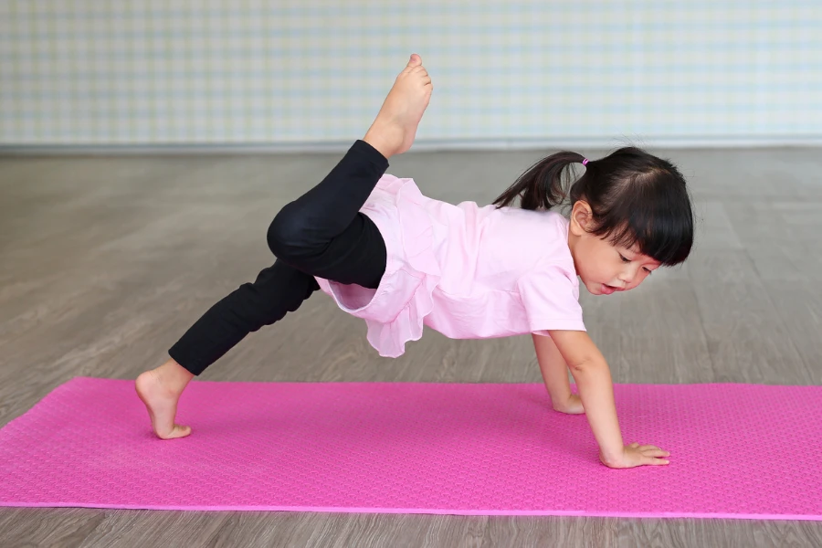 Cute toddler girl practicing yoga