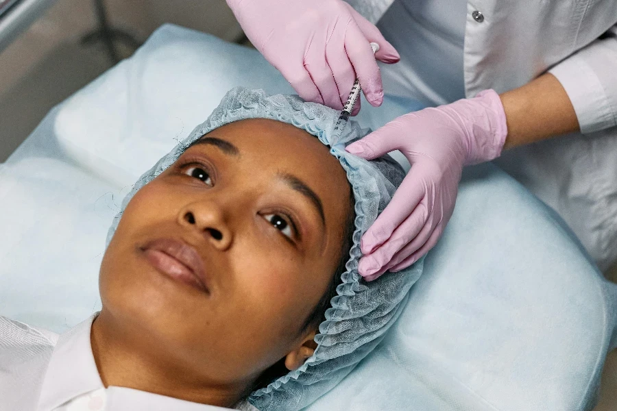 Dermatologist Injecting Botox on Clients Forehead by cottonbro studio