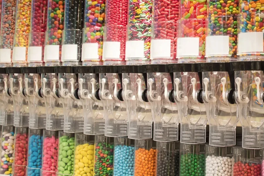 Display of many different type of colorful candy in transparent tubes