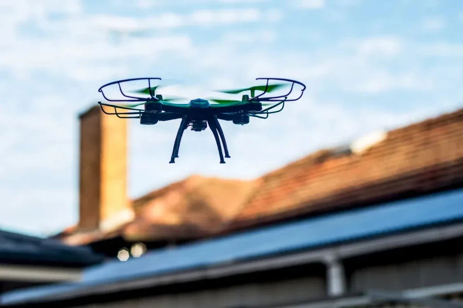 Drone quad copter flying over the roofs