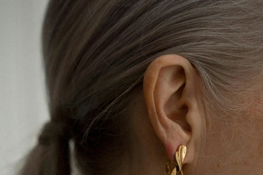 Elderly Woman Wearing Gold Earring