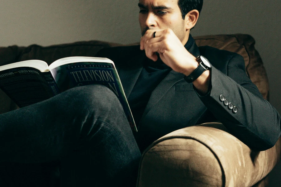 Elegant man with book on sofa