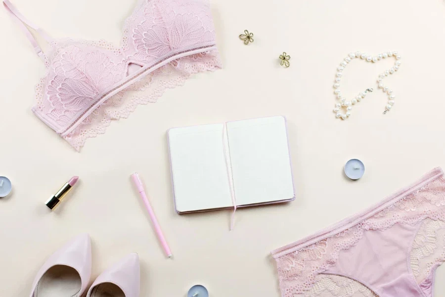 Fashion blogger workspace with woman elegant pink lace bra