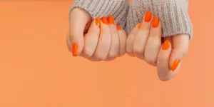 Female hands with orange manicure