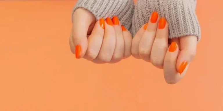 Female hands with orange manicure