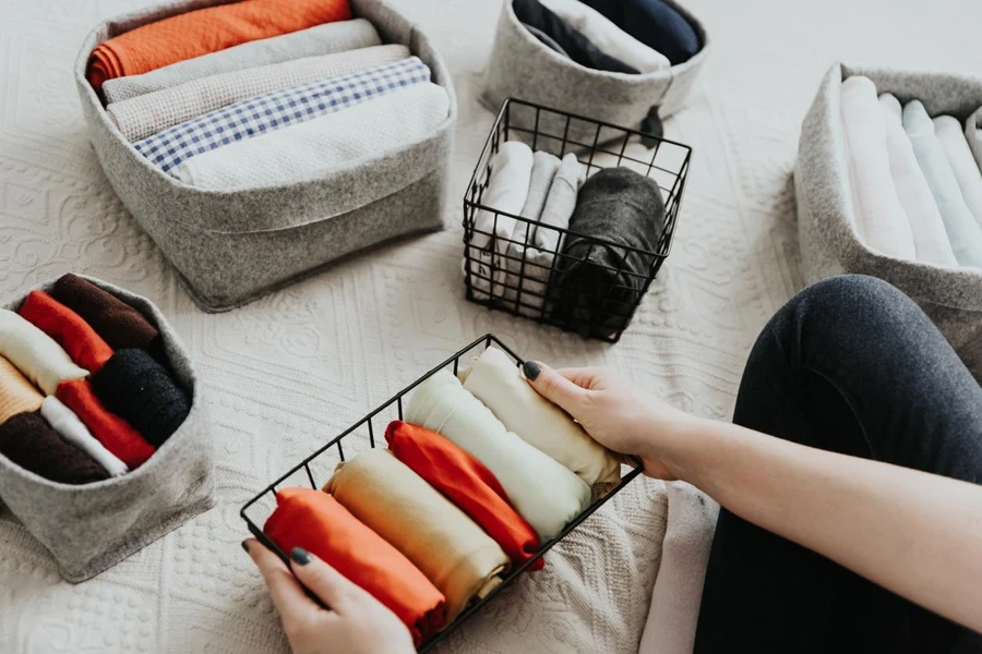 Folding clothes and organizing stuff in boxes and baskets